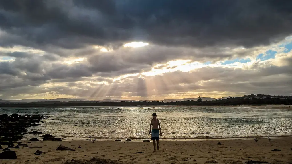 Sun breaking through clouds over Merimbula Bar Beach